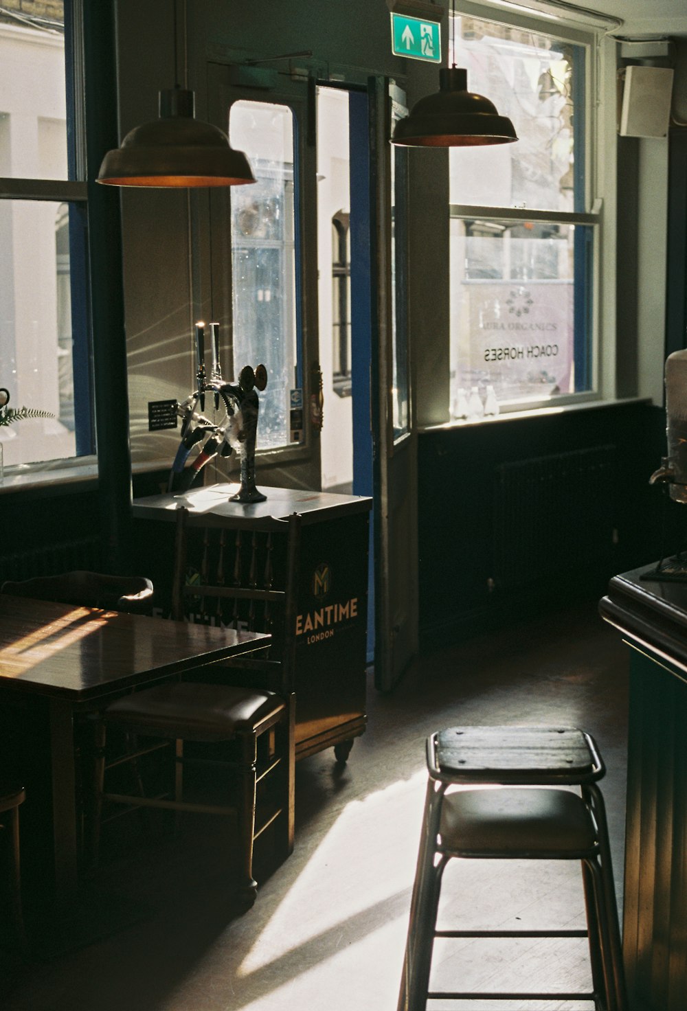 a room with a table, chairs, and a window