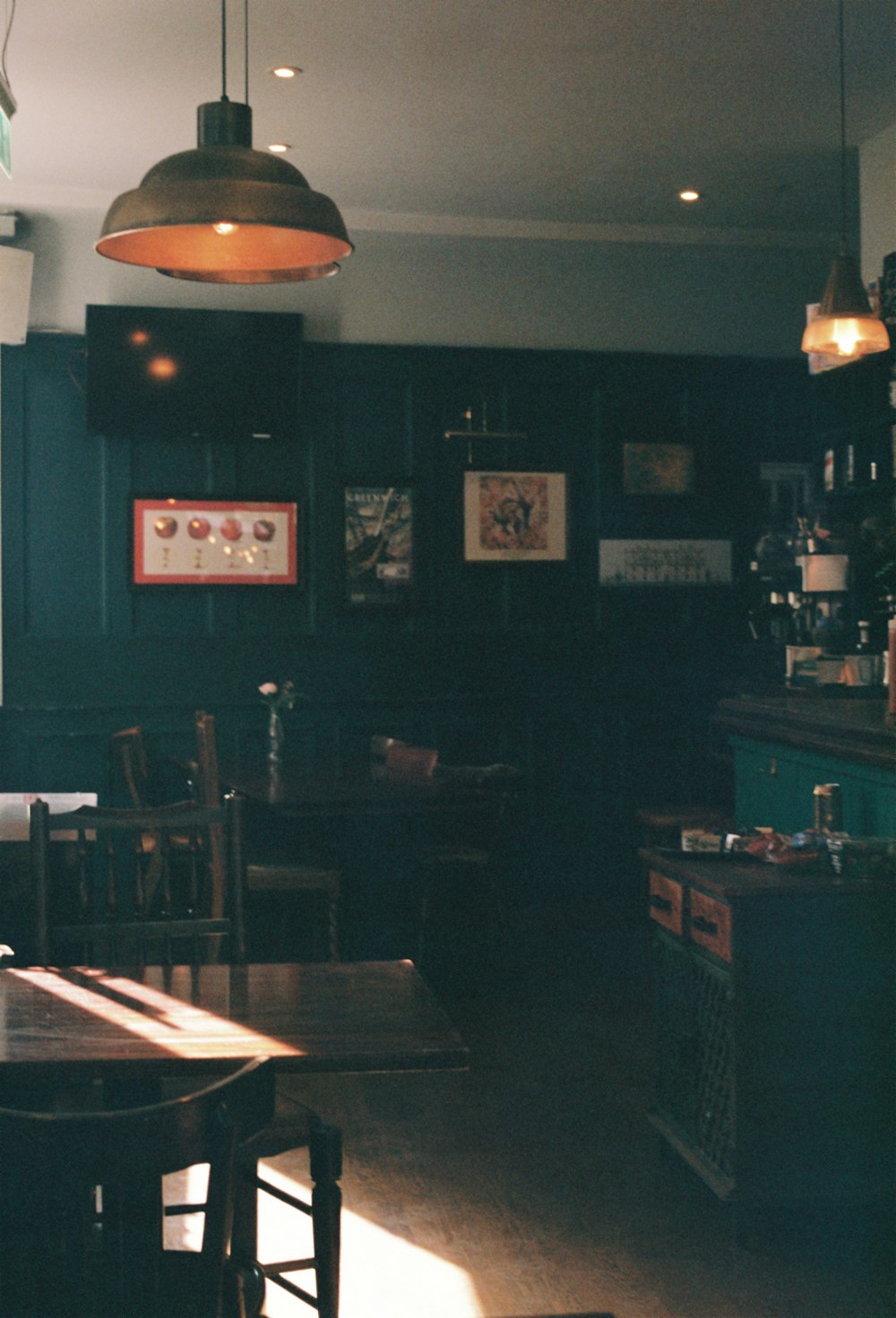 a dimly lit room with a wooden table and chairs