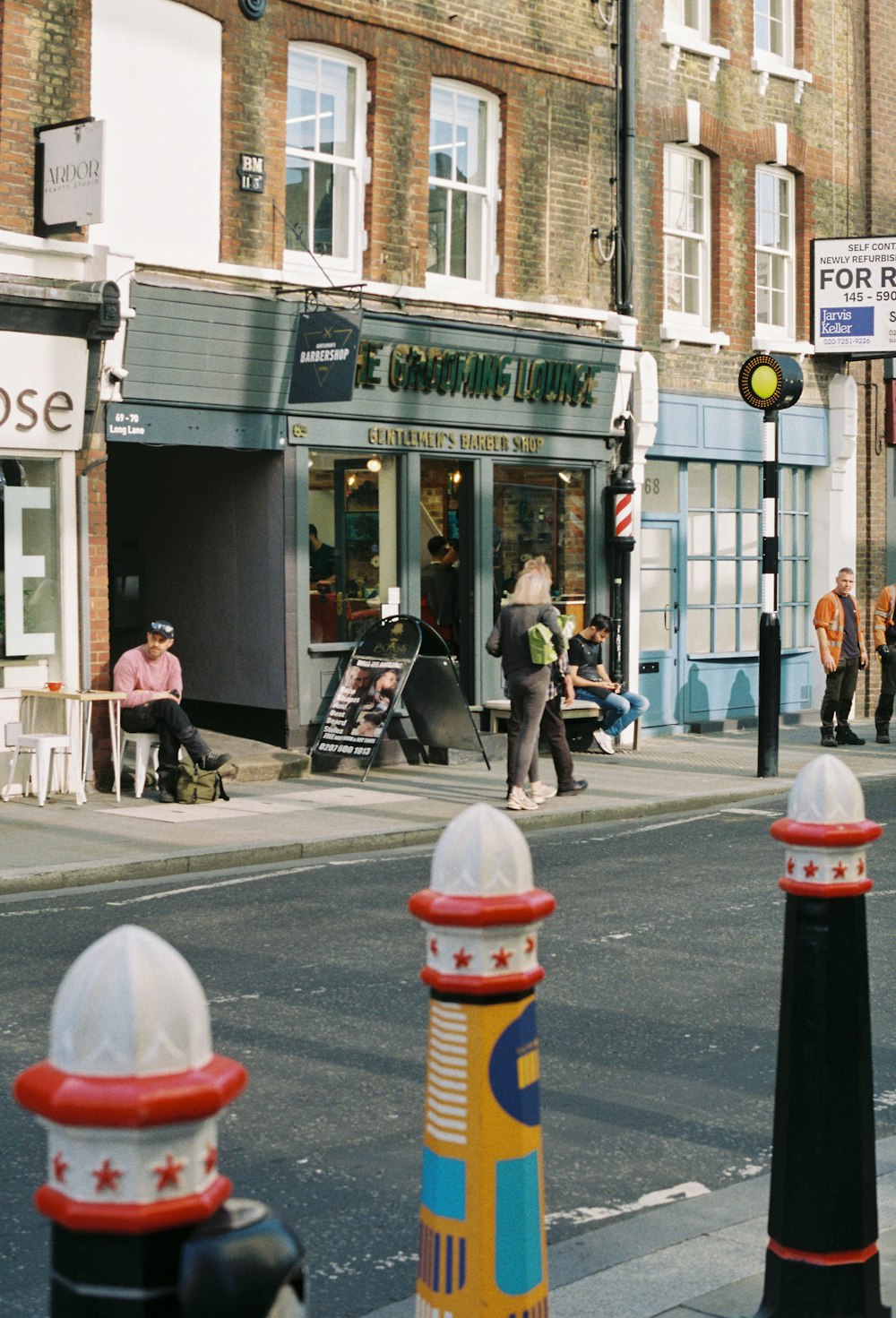 a city street with people walking on the sidewalk