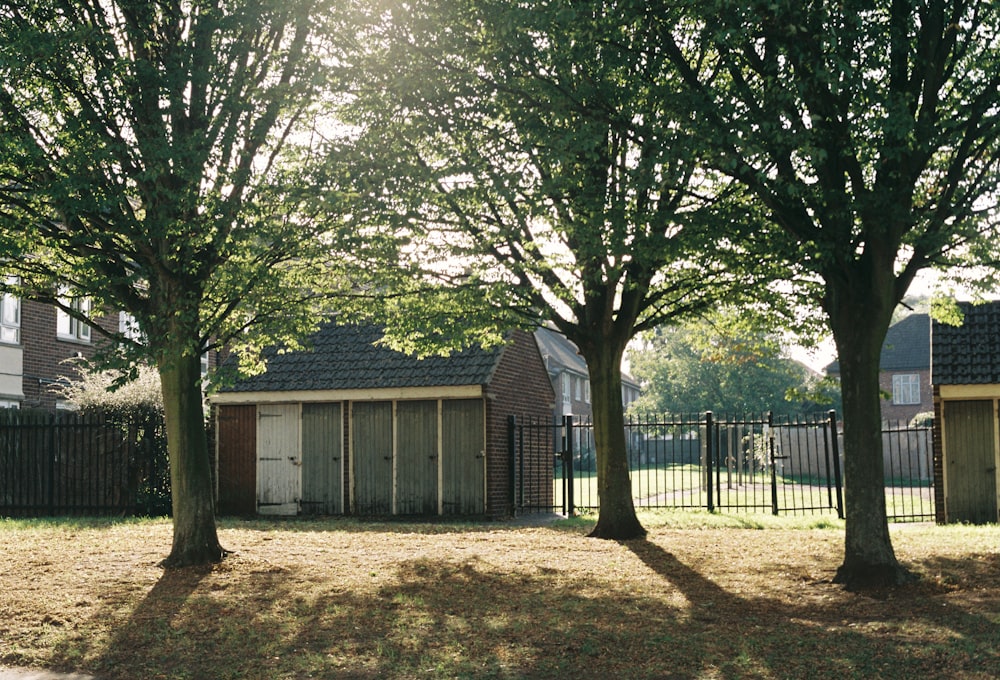 a row of houses sitting next to each other on a lush green field