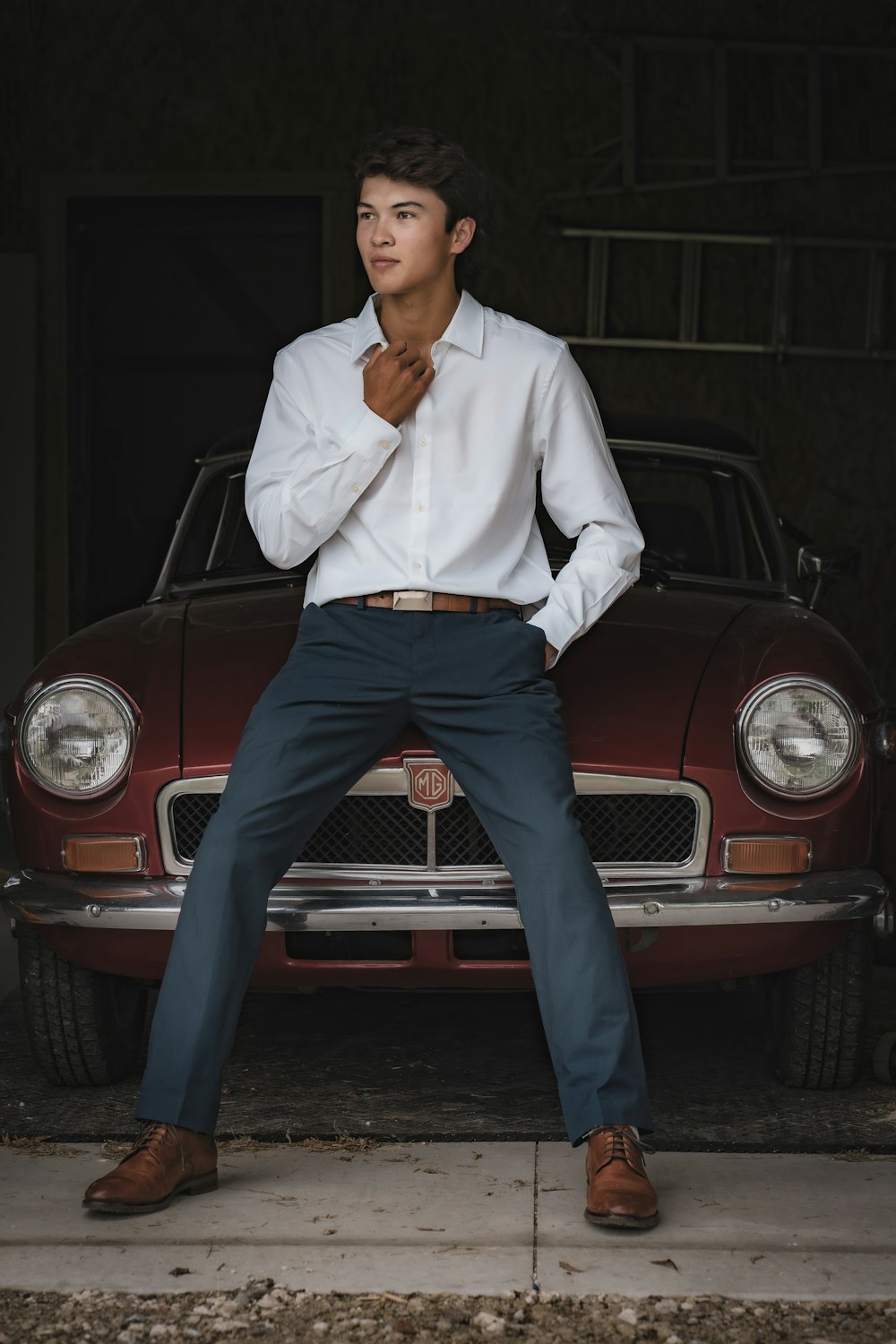 a man sitting on the hood of a car