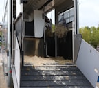 a horse trailer with hay inside of it