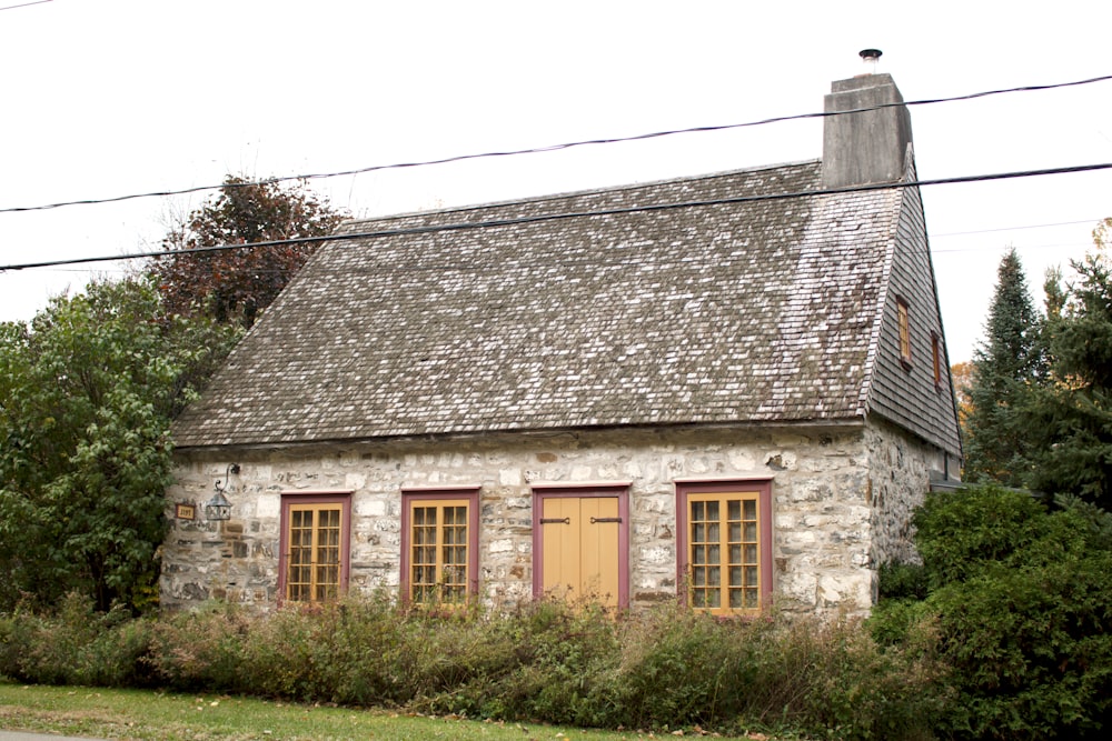 an old stone house with a yellow door