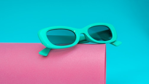 Trendy sunglasses on a vibrant surface.