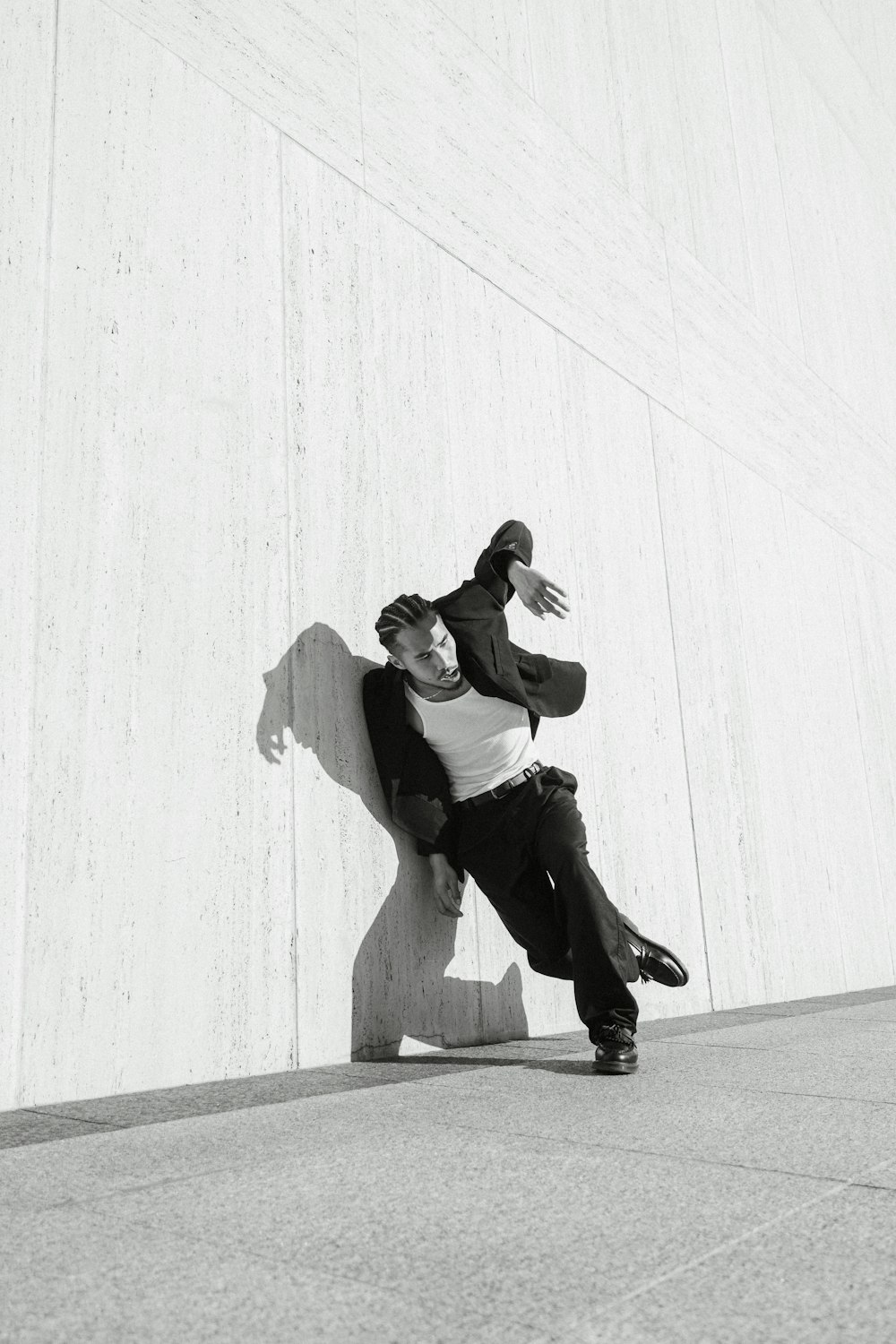 a couple of men sitting on top of a cement wall