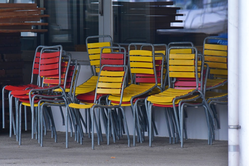 a row of yellow and red chairs sitting next to each other