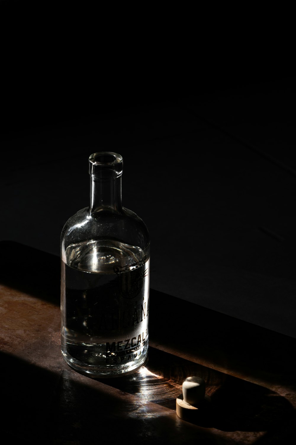 a bottle of water sitting on top of a wooden table