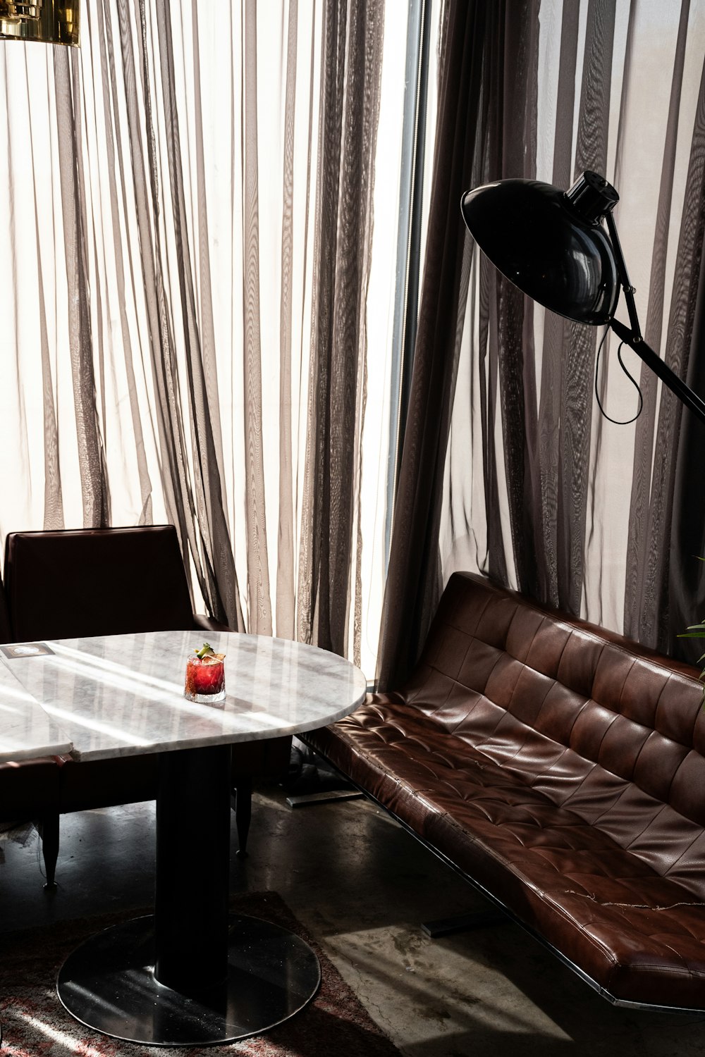 a room with a couch, table and a lamp