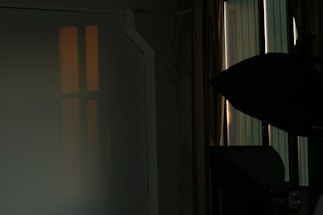 A warm photo studio corner with a camera and soft natural light.