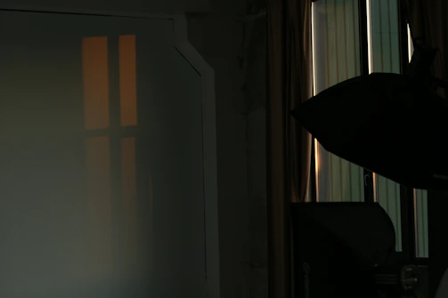 Soft sunlight filtering through a studio window onto an artistic workspace.