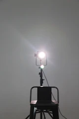 A simple stage setup with a single chair and soft spotlight