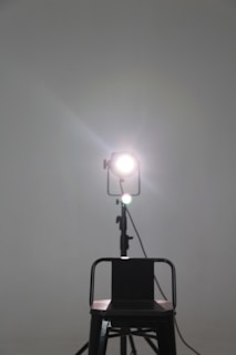 A quiet studio corner with a single chair and a spotlight