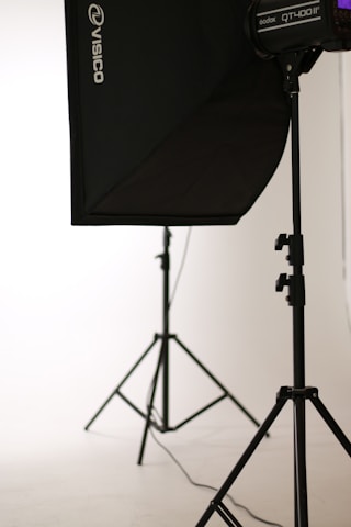 A sleek, minimalist photo studio setup with black, red, and white accents reflecting luxury and professionalism.