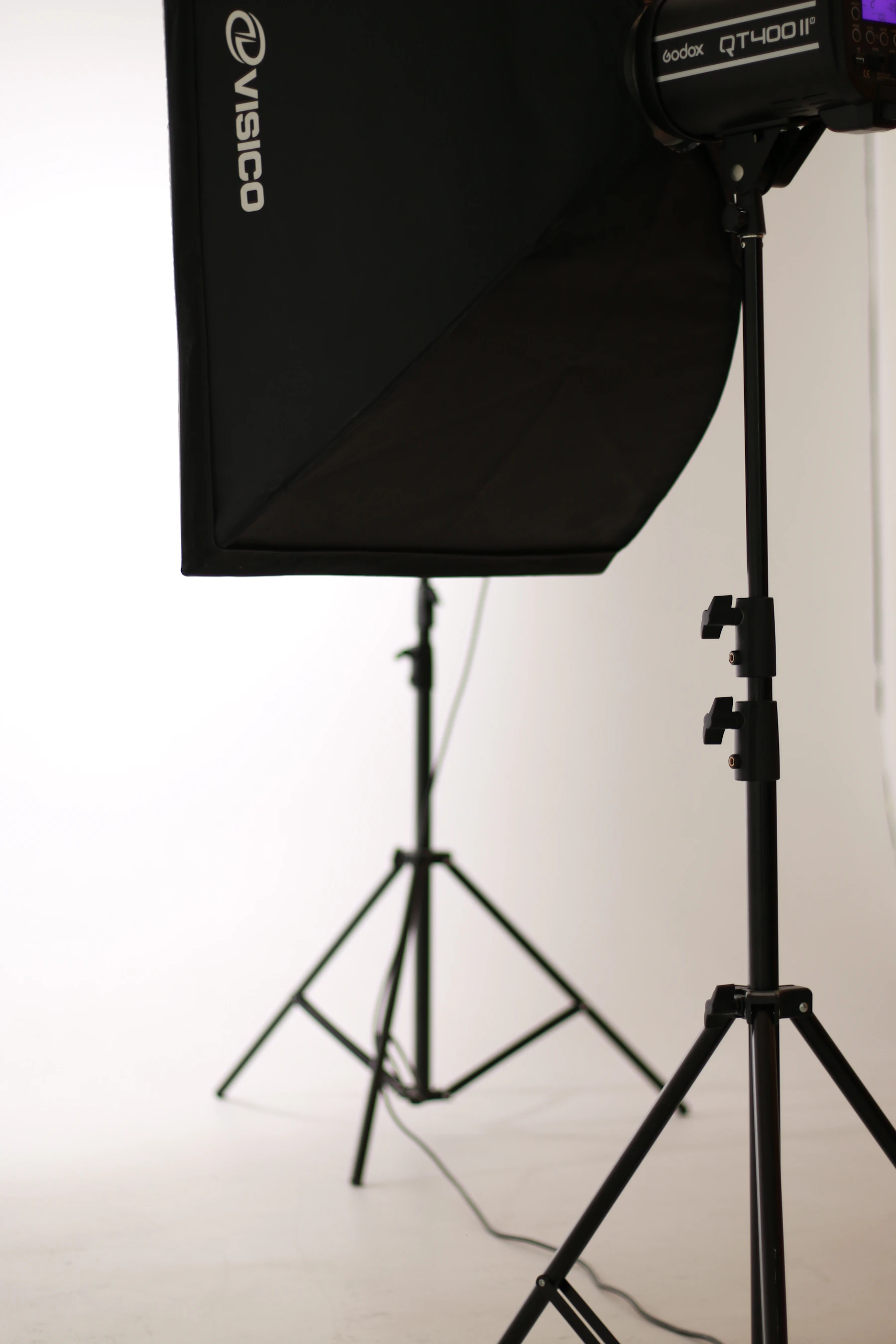 a photo studio with a light and a tripod