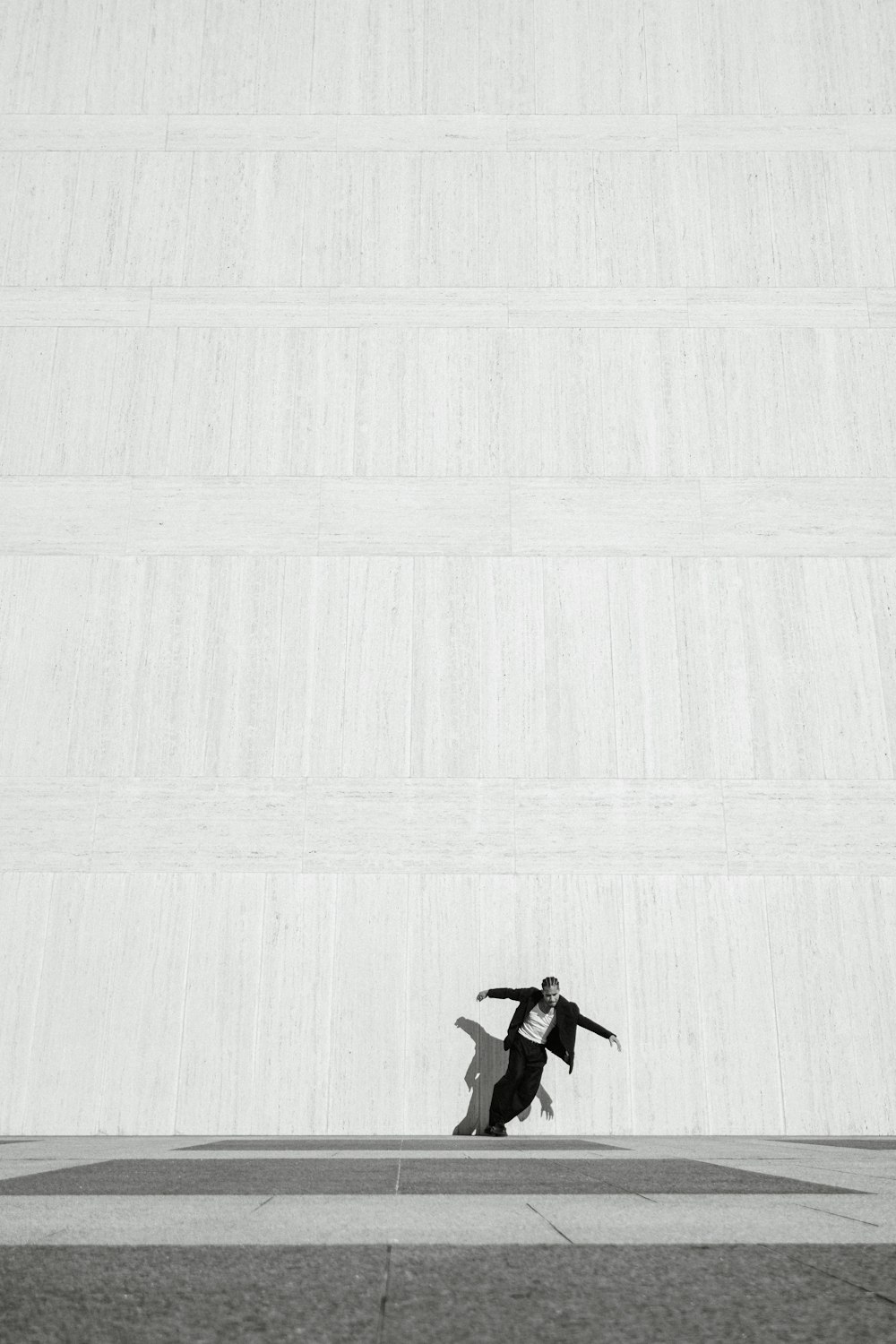 a man riding a skateboard across a cement floor