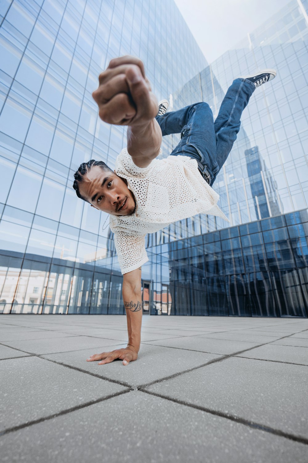 a man doing a handstand in front of a building