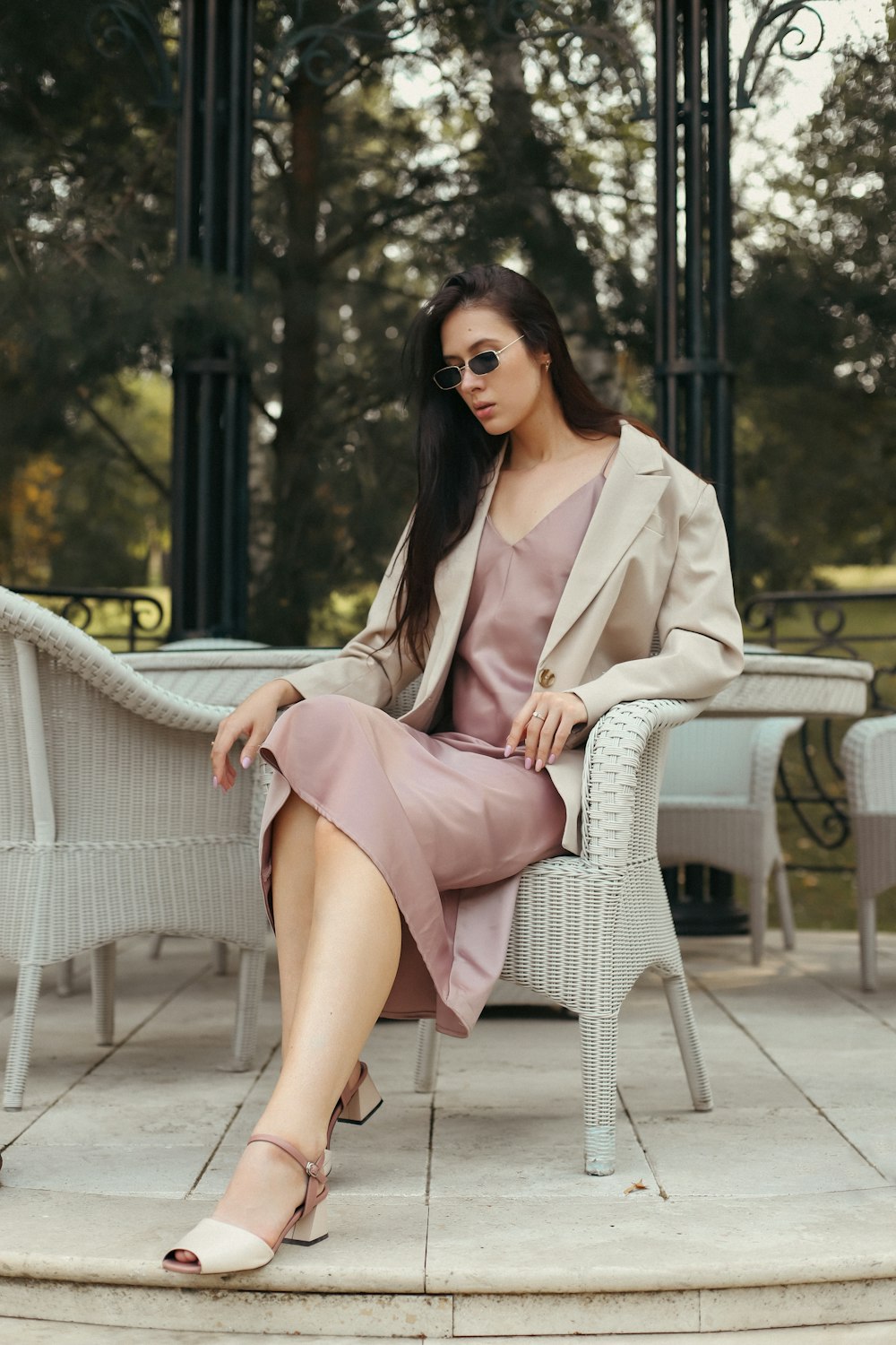 a woman sitting on a chair in a dress