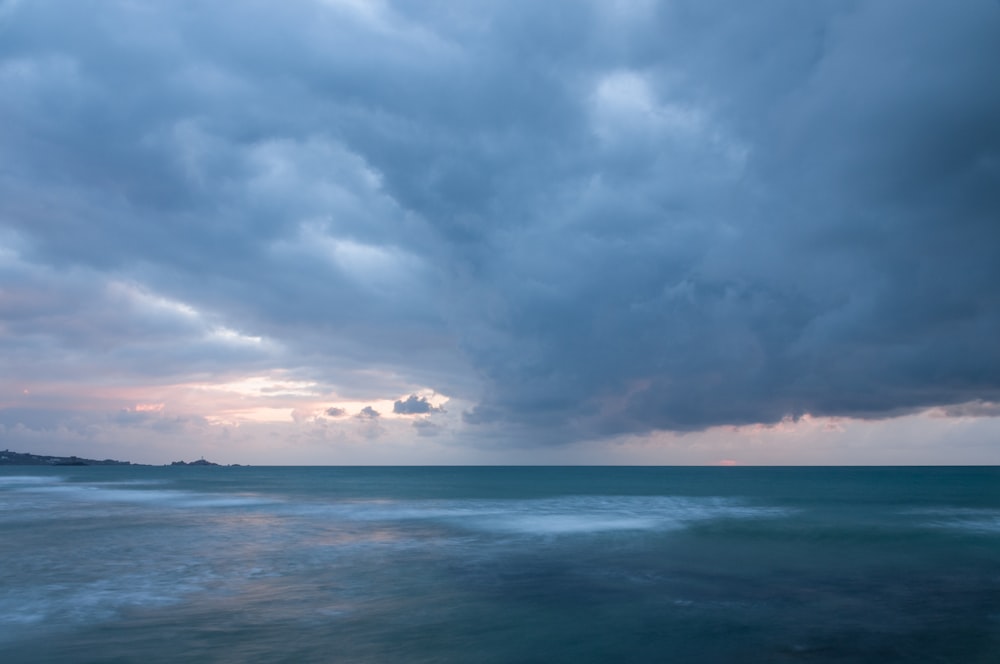 a large body of water under a cloudy sky