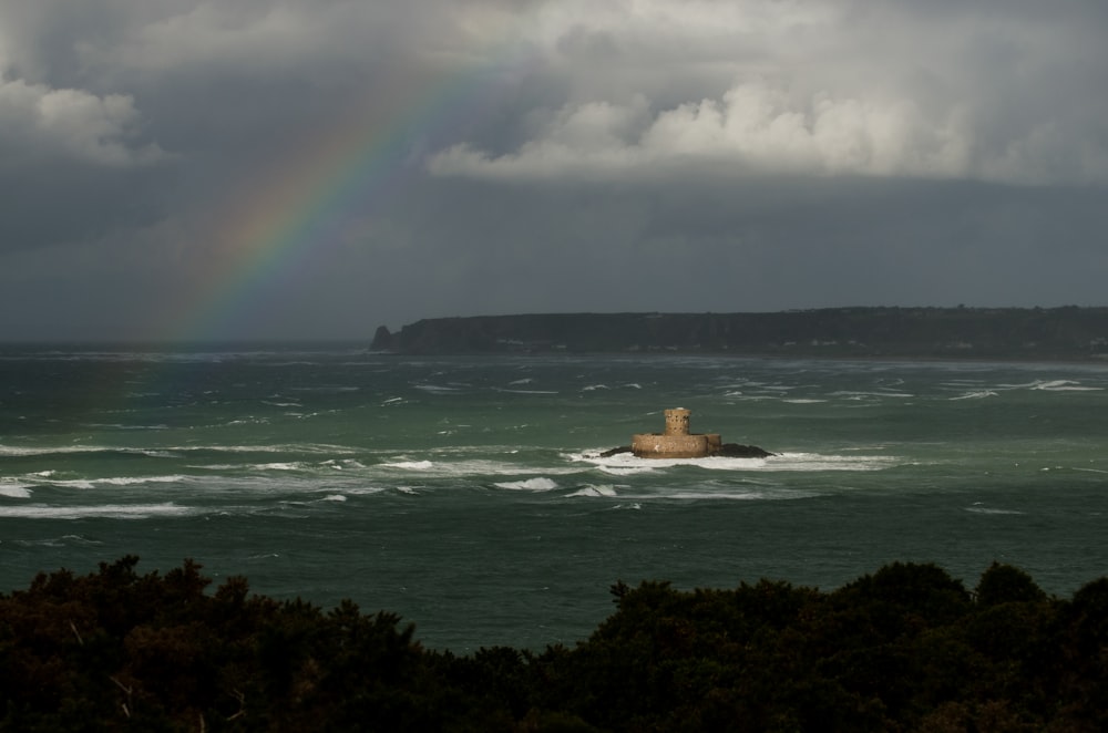 a rainbow in the sky over a body of water