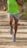 A person jogging on a scenic trail wearing comfortable running shoes.