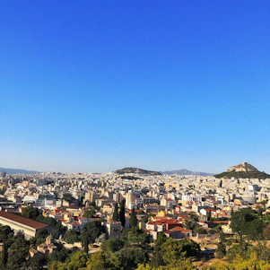A panoramic view of the Sarjapur Heights residential towers with lush landscaping under a clear blue sky.