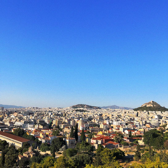 A panoramic view of the Sarjapur Heights residential towers with lush landscaping under a clear blue sky.