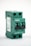 A green electrical circuit breaker with two switches is shown from a side angle. The breaker has visible text and labels, including 'FPV-63' and 'C32'. The overall design is boxy with two black switches and multiple openings for wiring connections.
