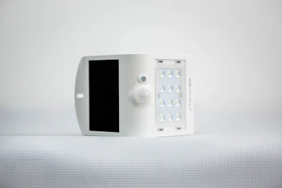Compact solar power inverter installed on a wall with glowing indicator lights