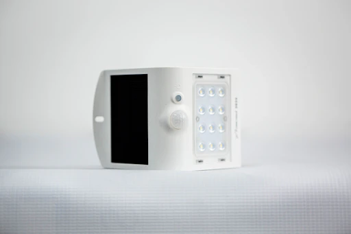 A team member holding a compact perovskite panel designed for IoT devices.