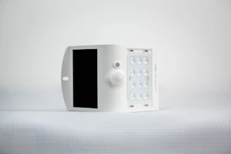 Compact solar power inverter installed on a wall with glowing indicator lights