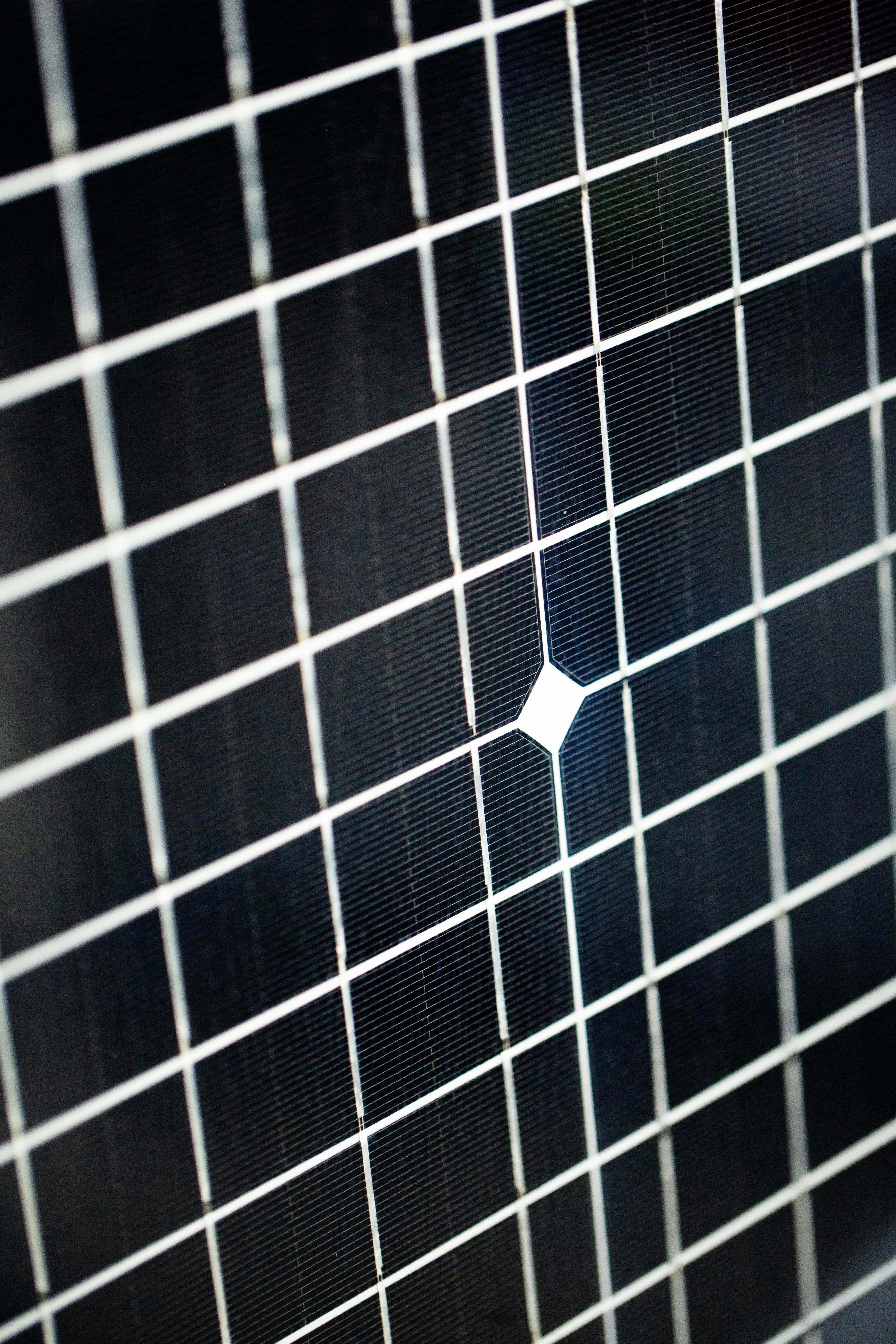 a black and white tiled wall with a white square