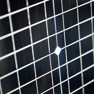 a black and white tiled wall with a white square