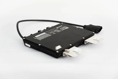 a close up of a black device with a white background