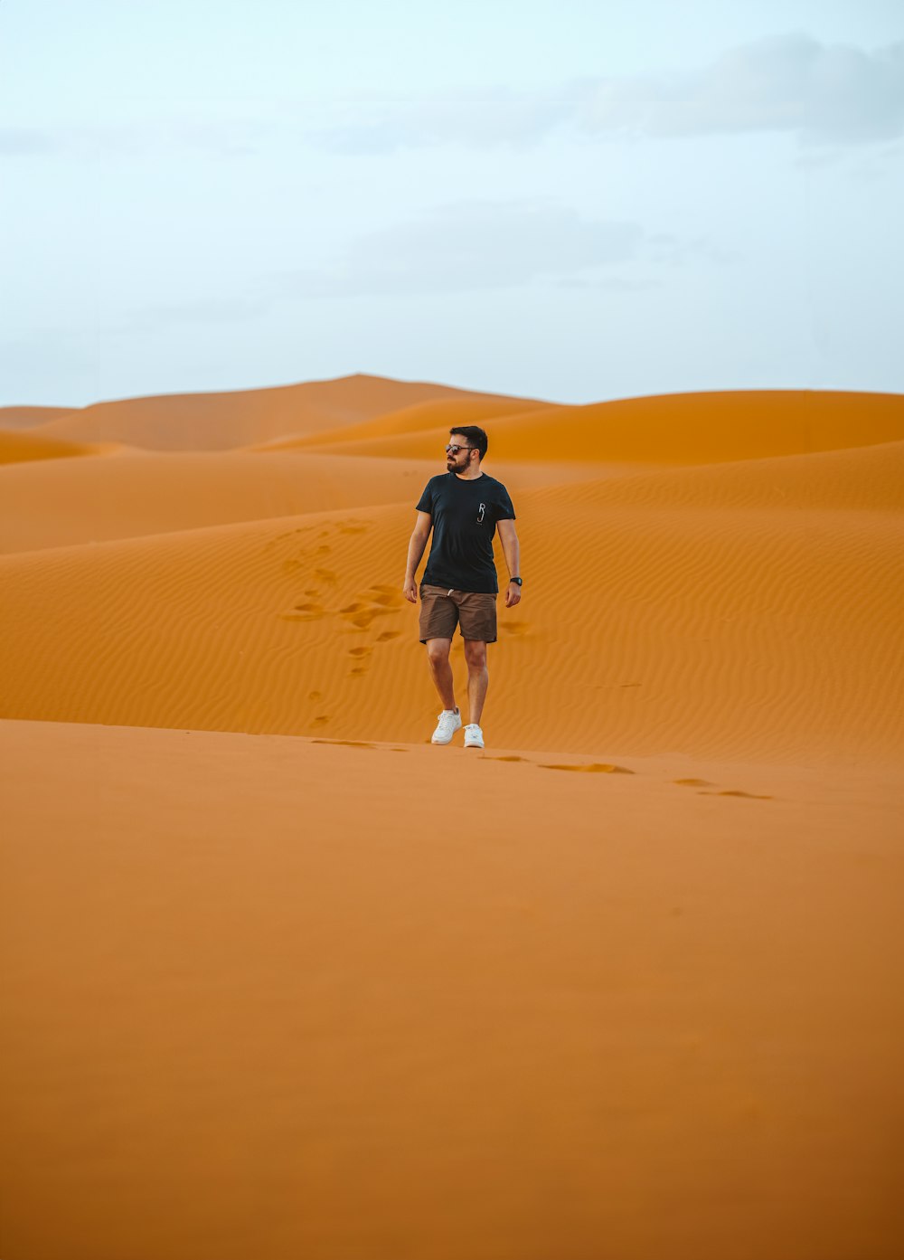 a man standing in the middle of a desert