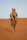 a man in a turban walks through the desert
