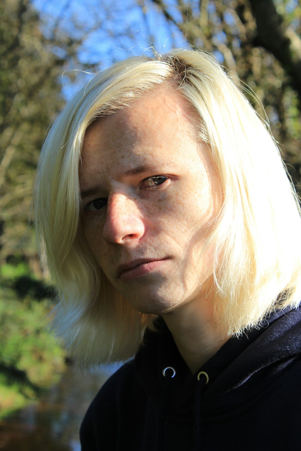 a man with blonde hair and a black shirt