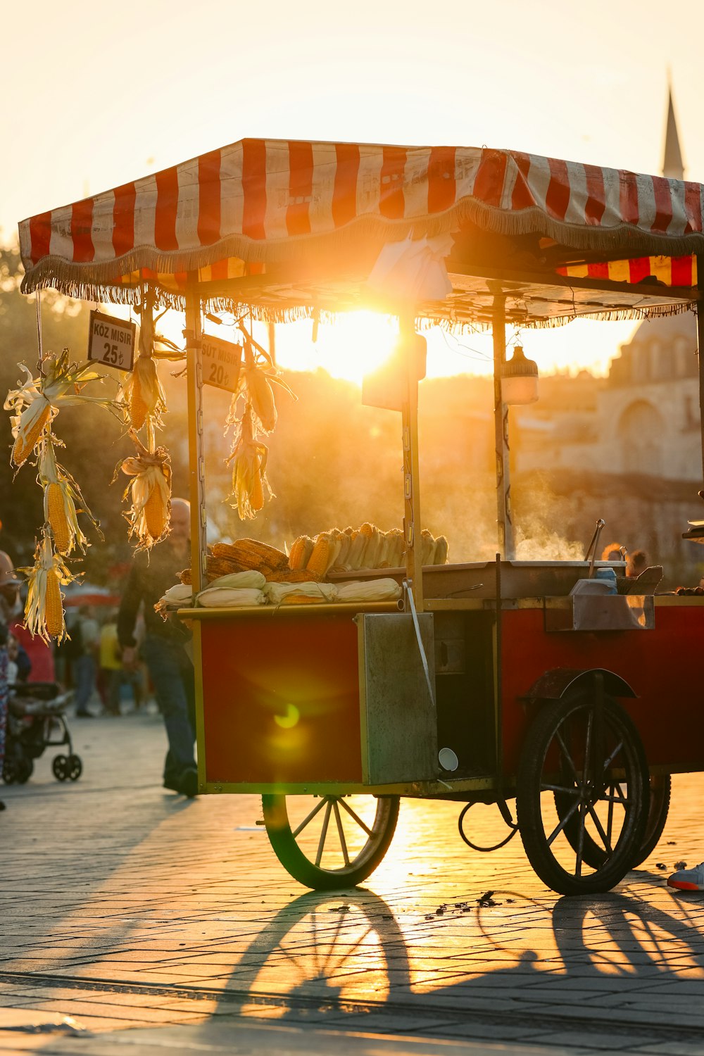 a cart with food on the street at sunset