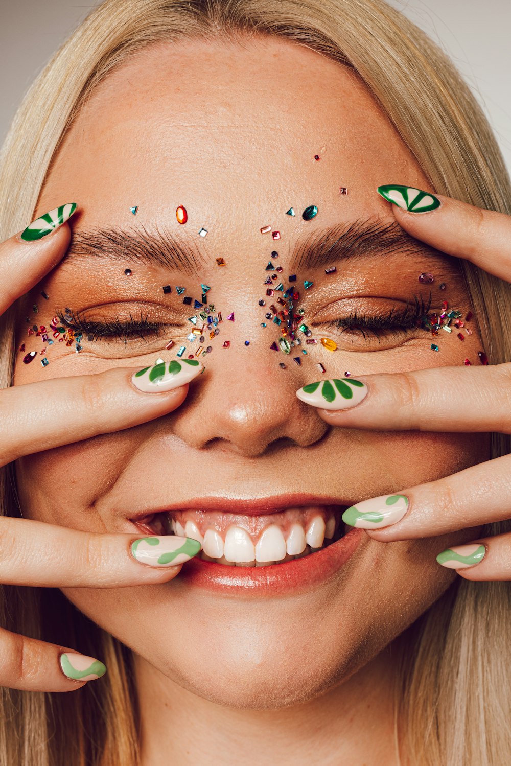 a woman with her hands on her face and her eyes closed