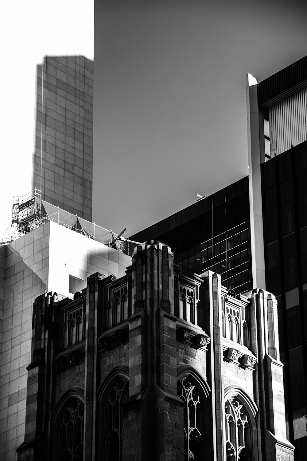 a black and white photo of a building and a plane