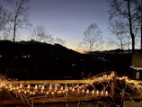Twilight scene of a serene mountain retreat with soft lighting and inviting outdoor spaces.