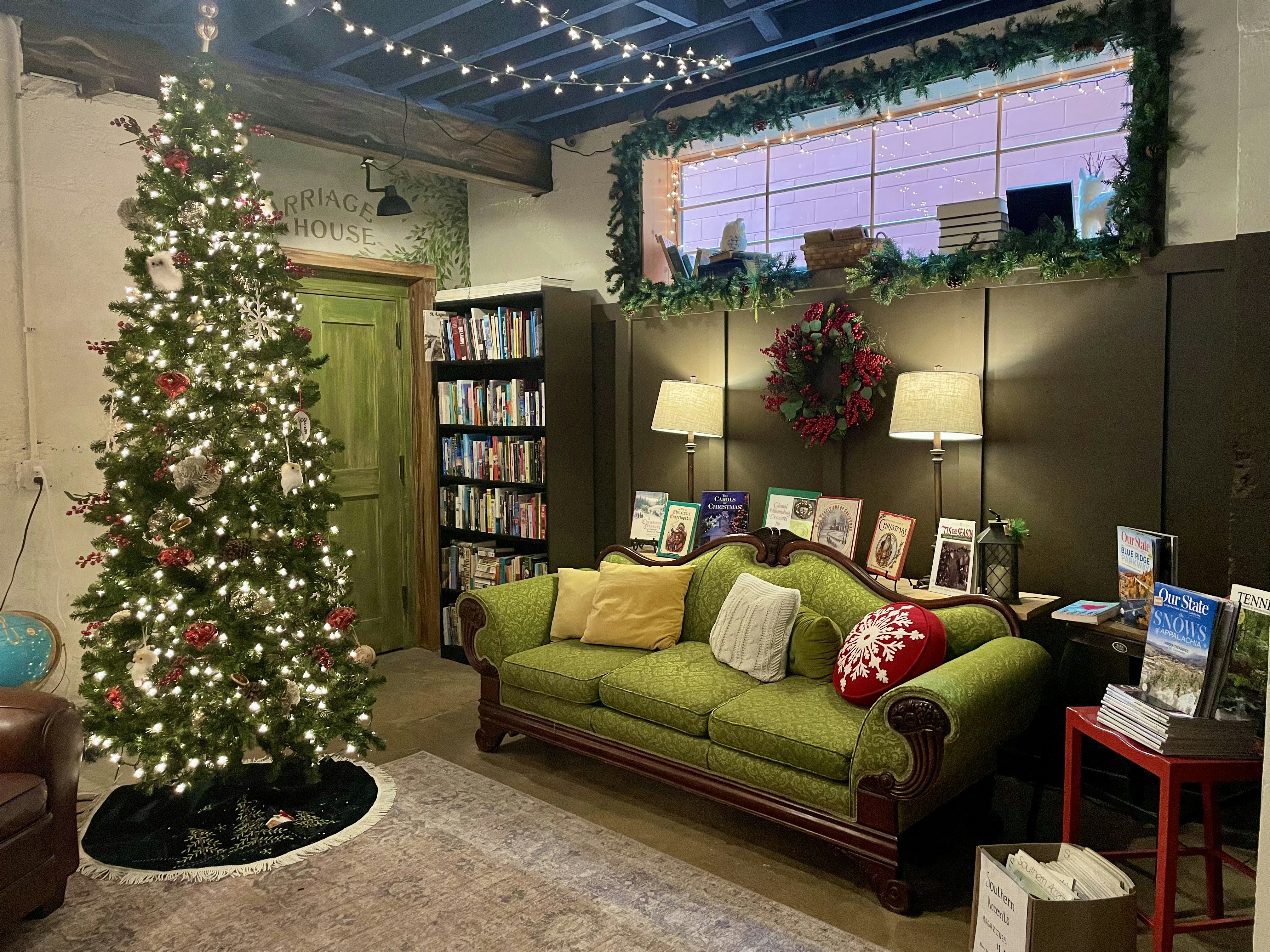 a living room filled with furniture and a christmas tree, 