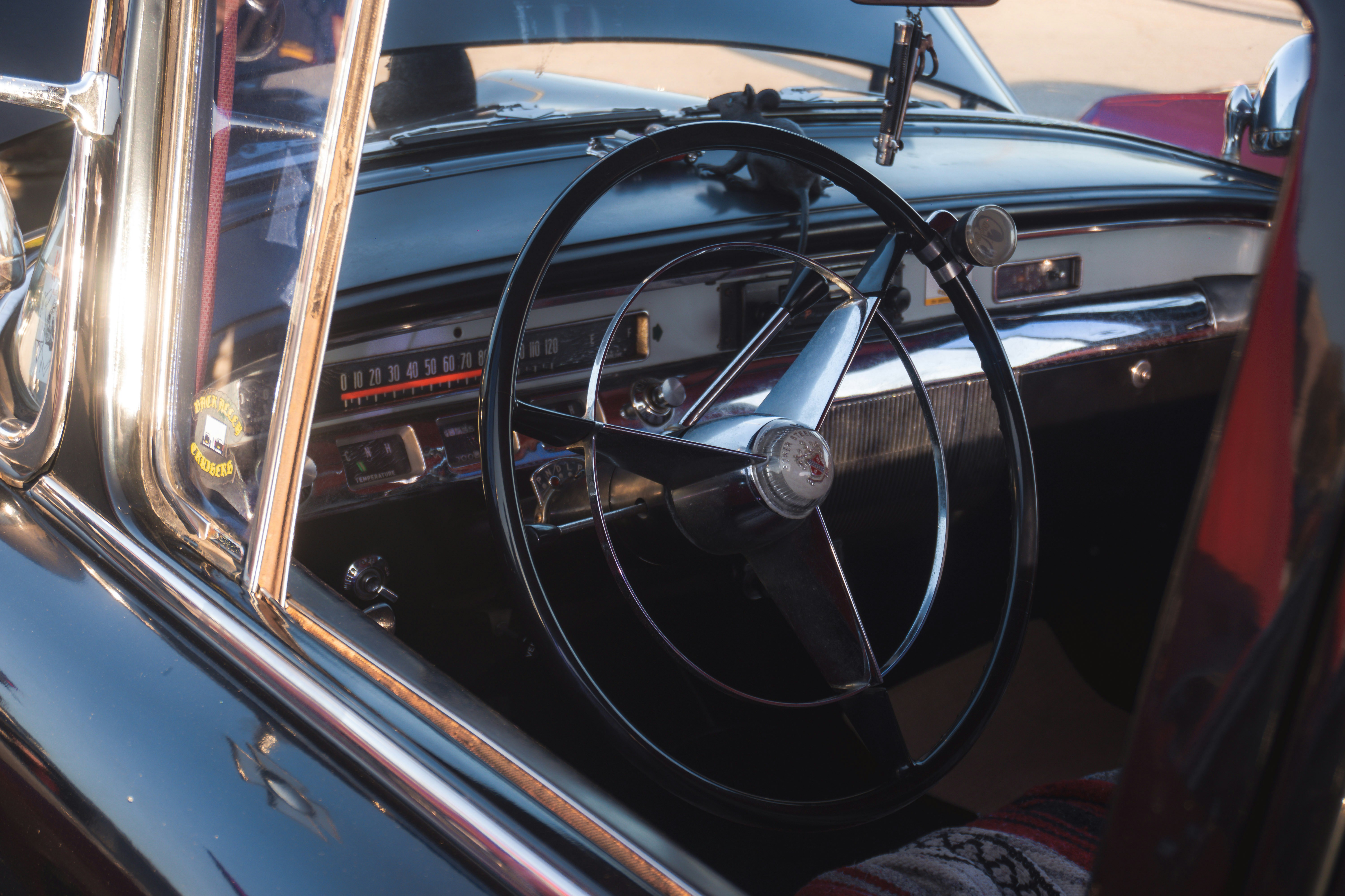 the interior of a classic car with a steering wheel
