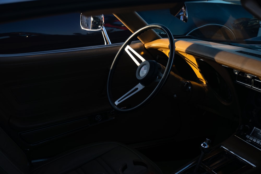 the interior of a car with a steering wheel and dashboard