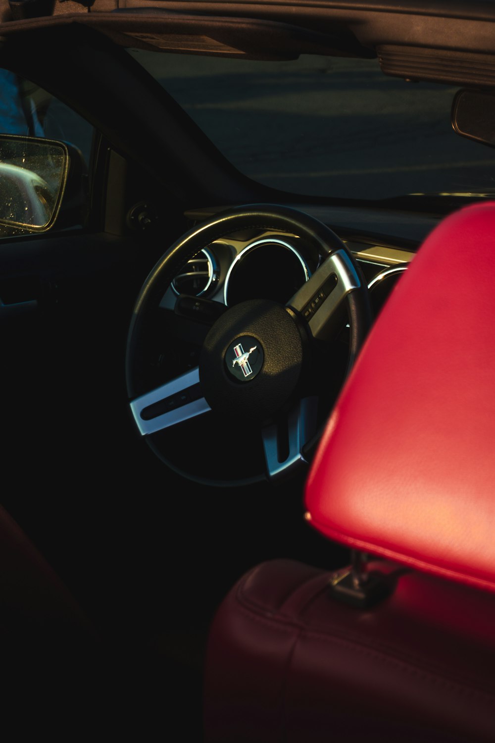 the interior of a car with a red seat