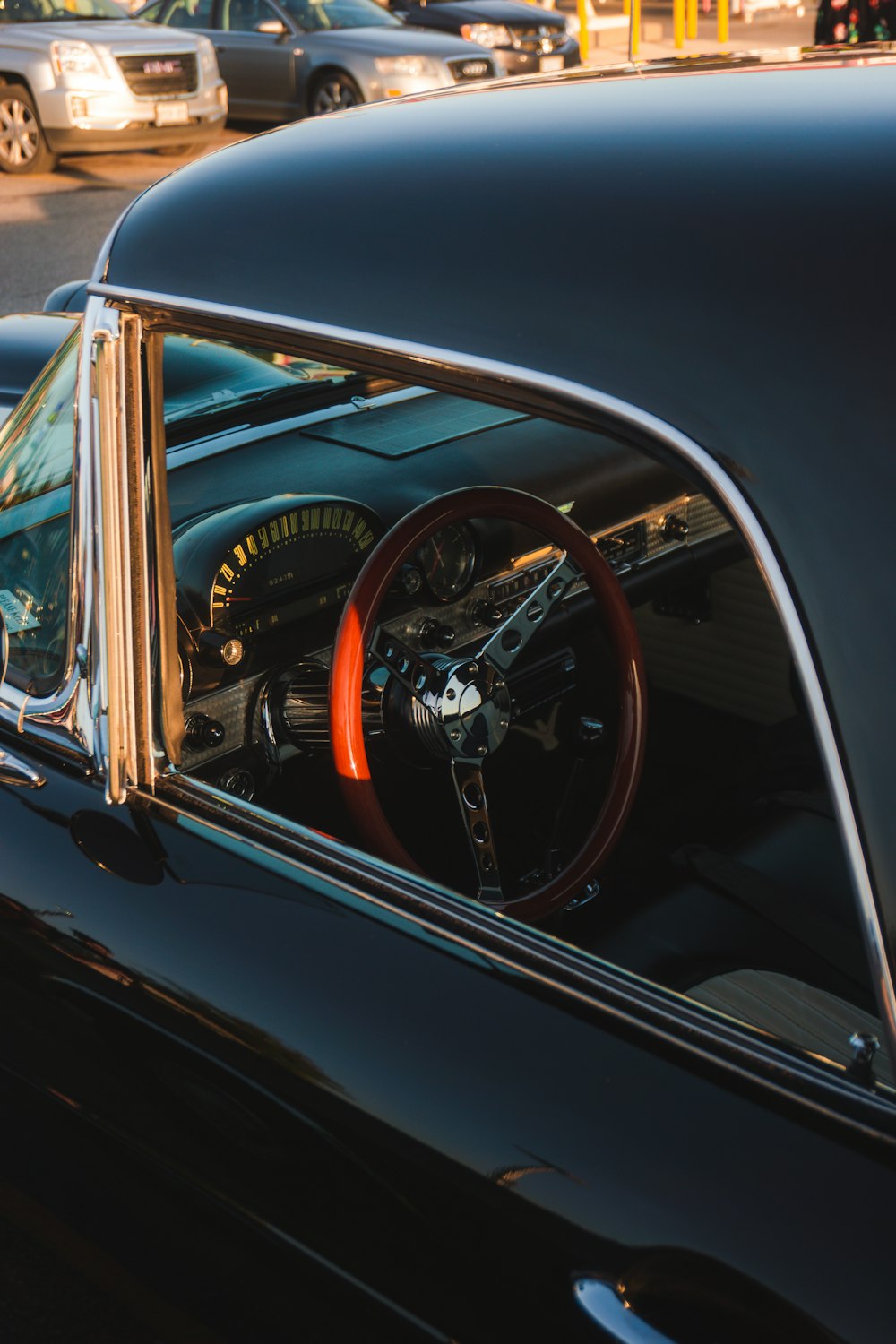 a black car with a red spokes and a steering wheel