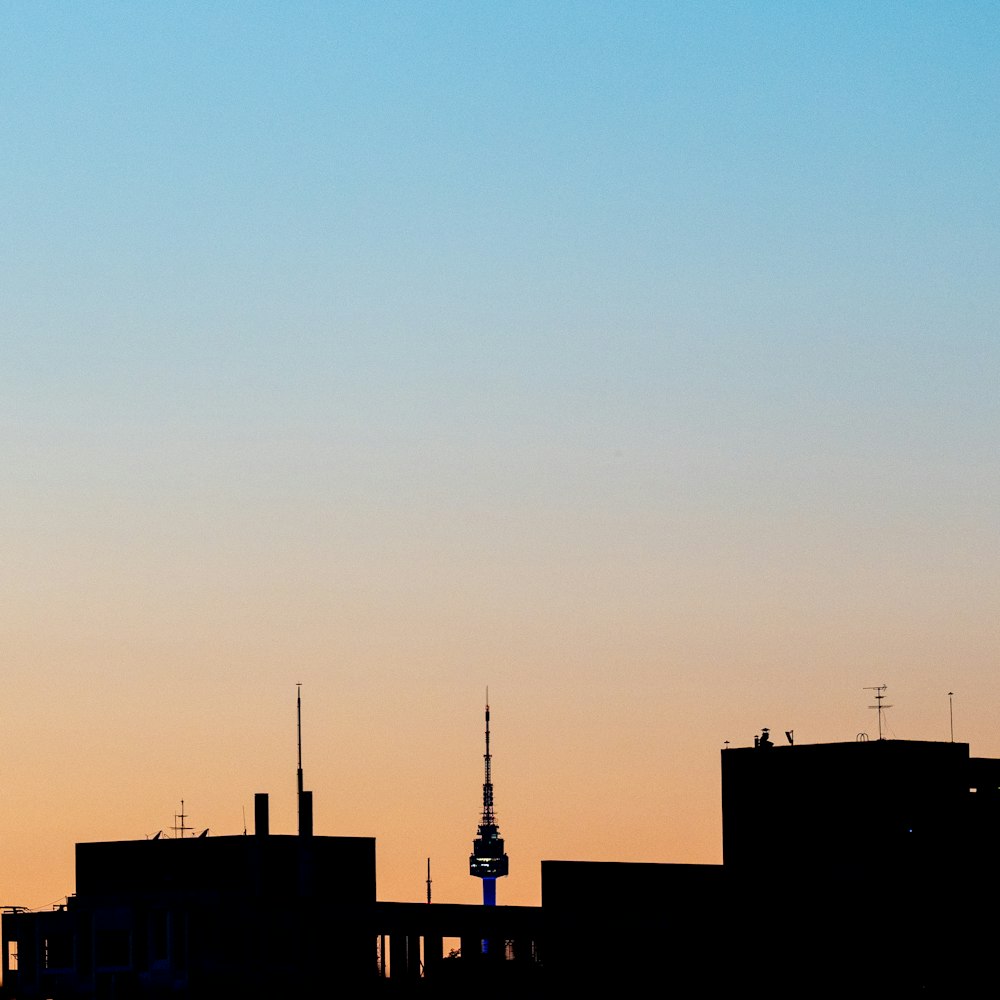 a plane flying over a city at sunset