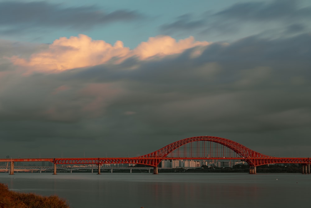a large red bridge over a large body of water