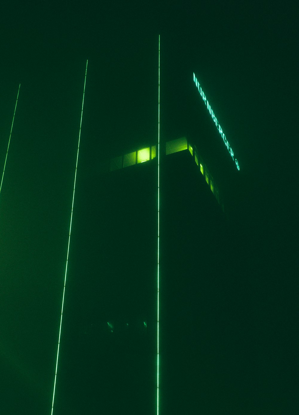 a tall building lit up in the dark