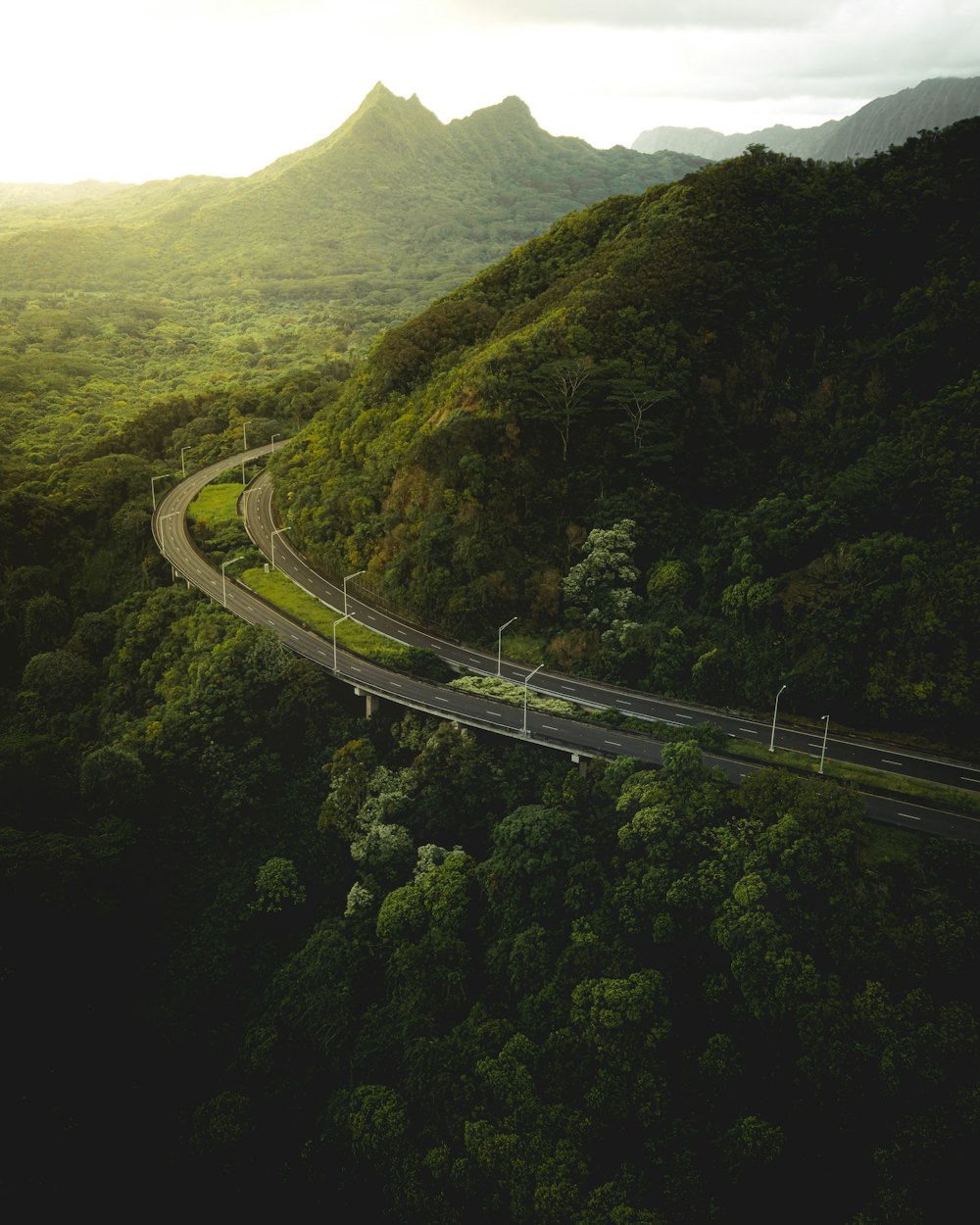 an aerial view of a winding road in the mountains