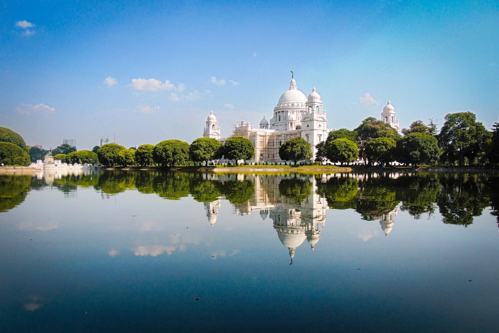 a large white building sitting on top of a lake